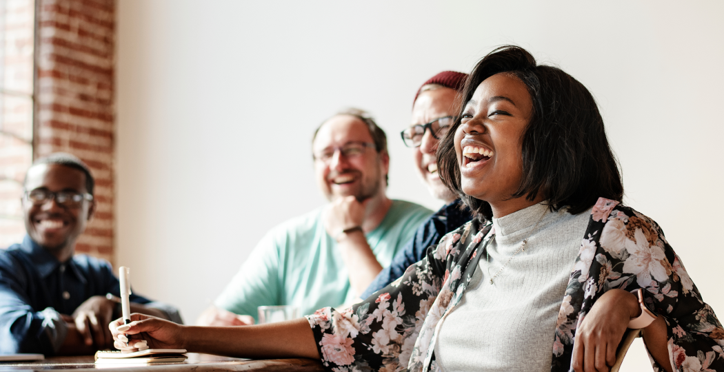 A team laughing together during a meeting